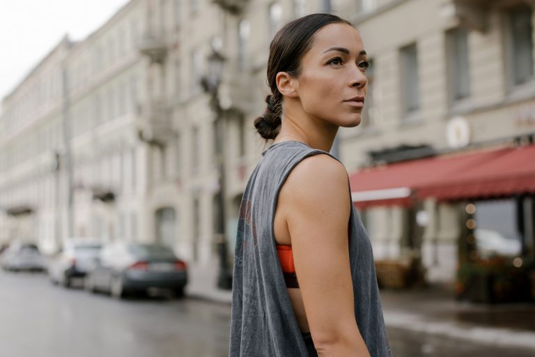 Confident woman walking through a city street, embodying strong body language and self-assurance