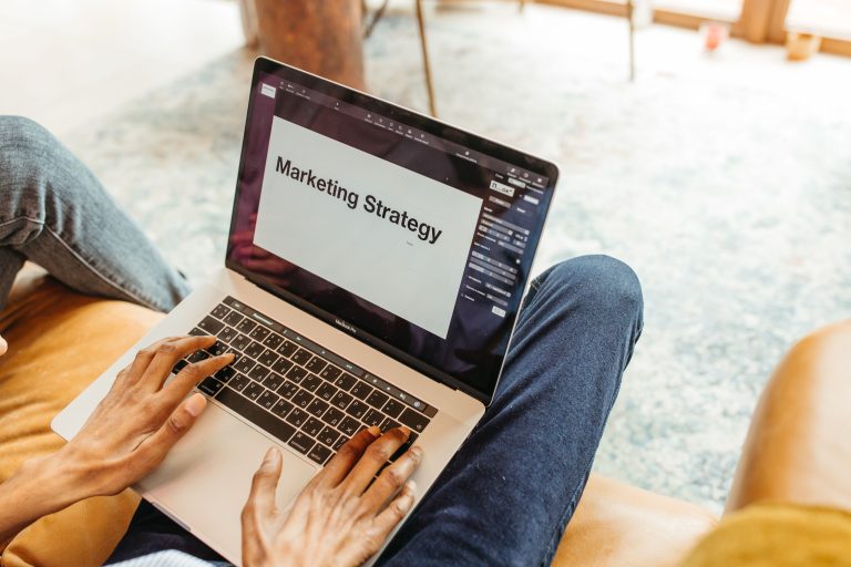 Entrepreneur reviewing a digital marketing strategy presentation on a laptop
