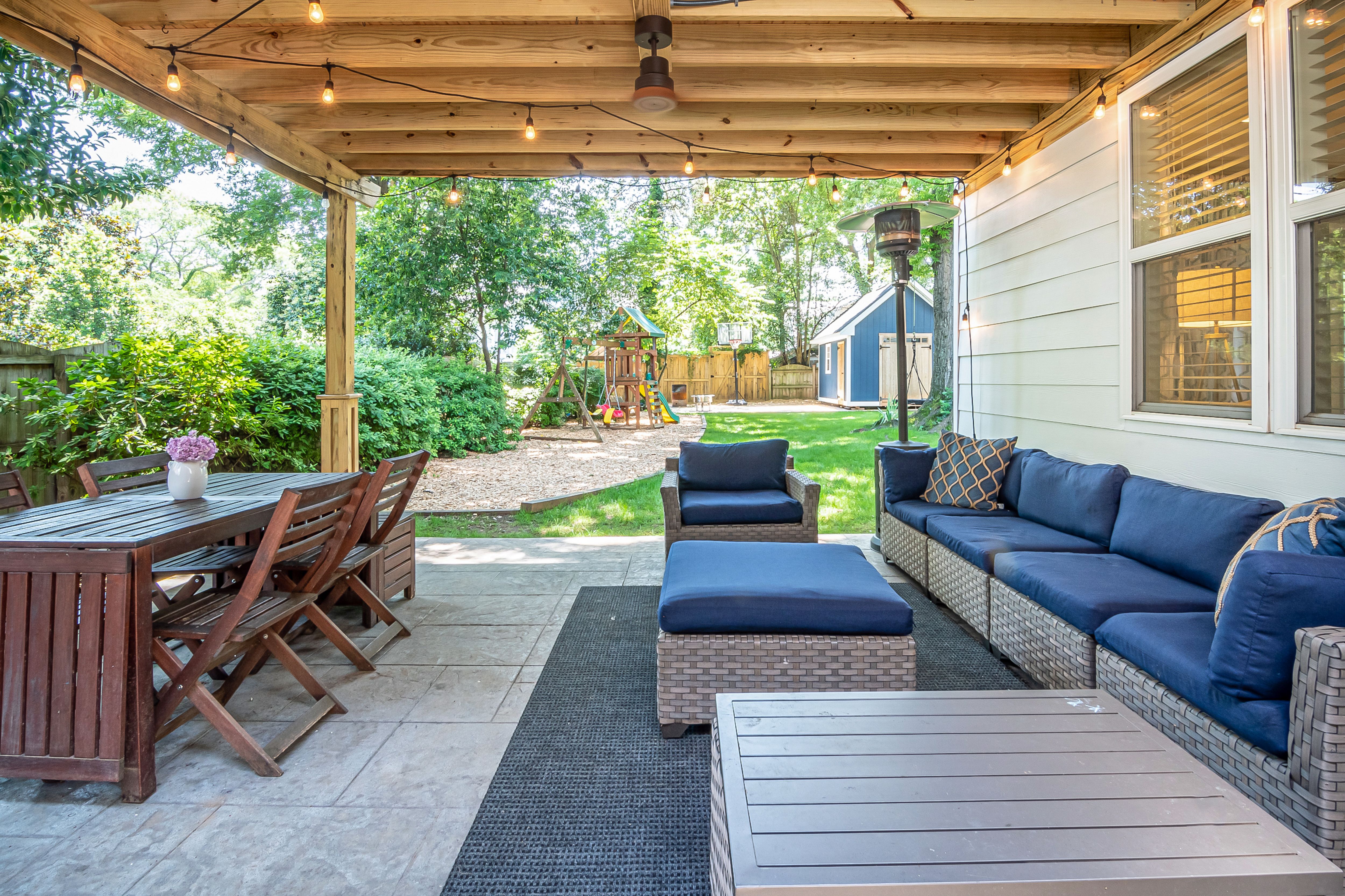 Backyard patio with comfortable seating and a wooden dining set for everyday outdoor meals.