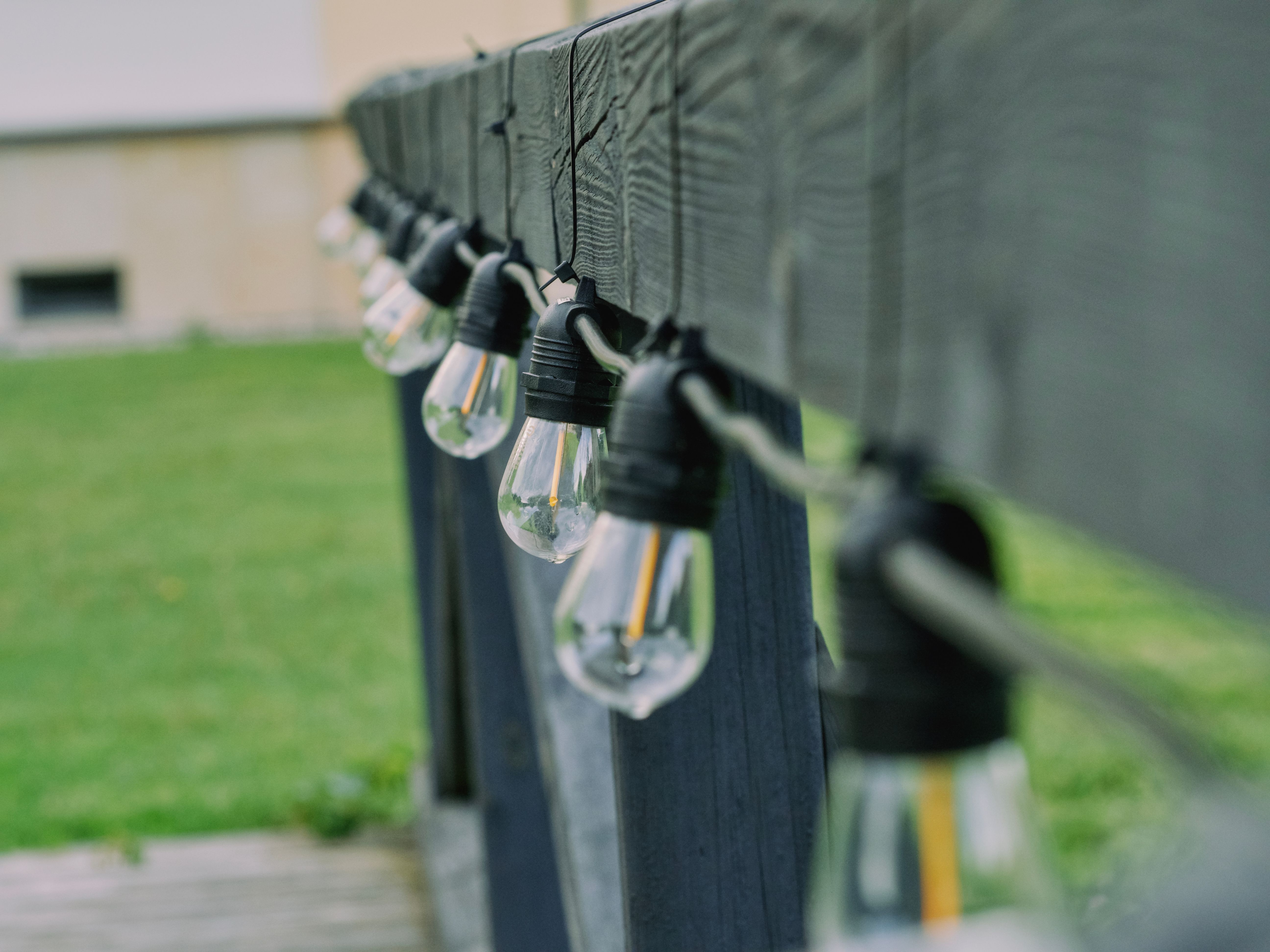 LED string lights mounted along an outdoor wooden rail, a practical small improvement for evening use.